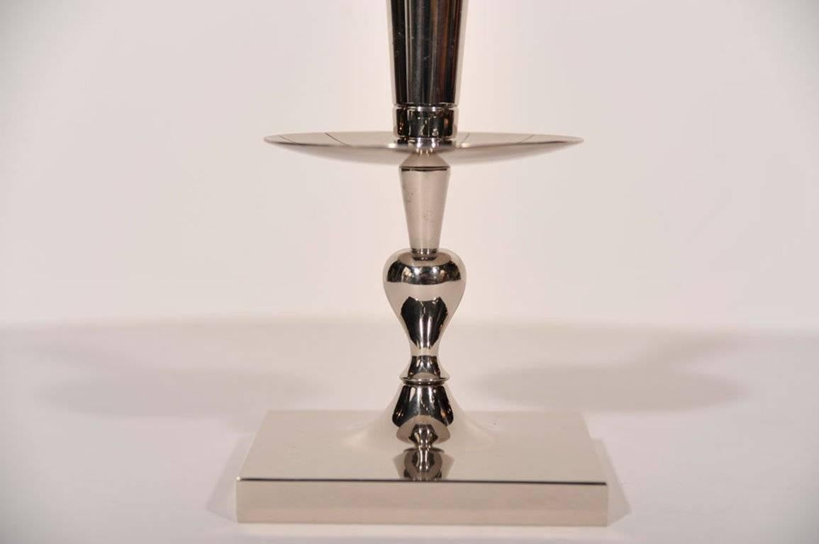 Pair of Mid-Century Classic candlesticks in polished nickel designed by Tommi Parzinger.