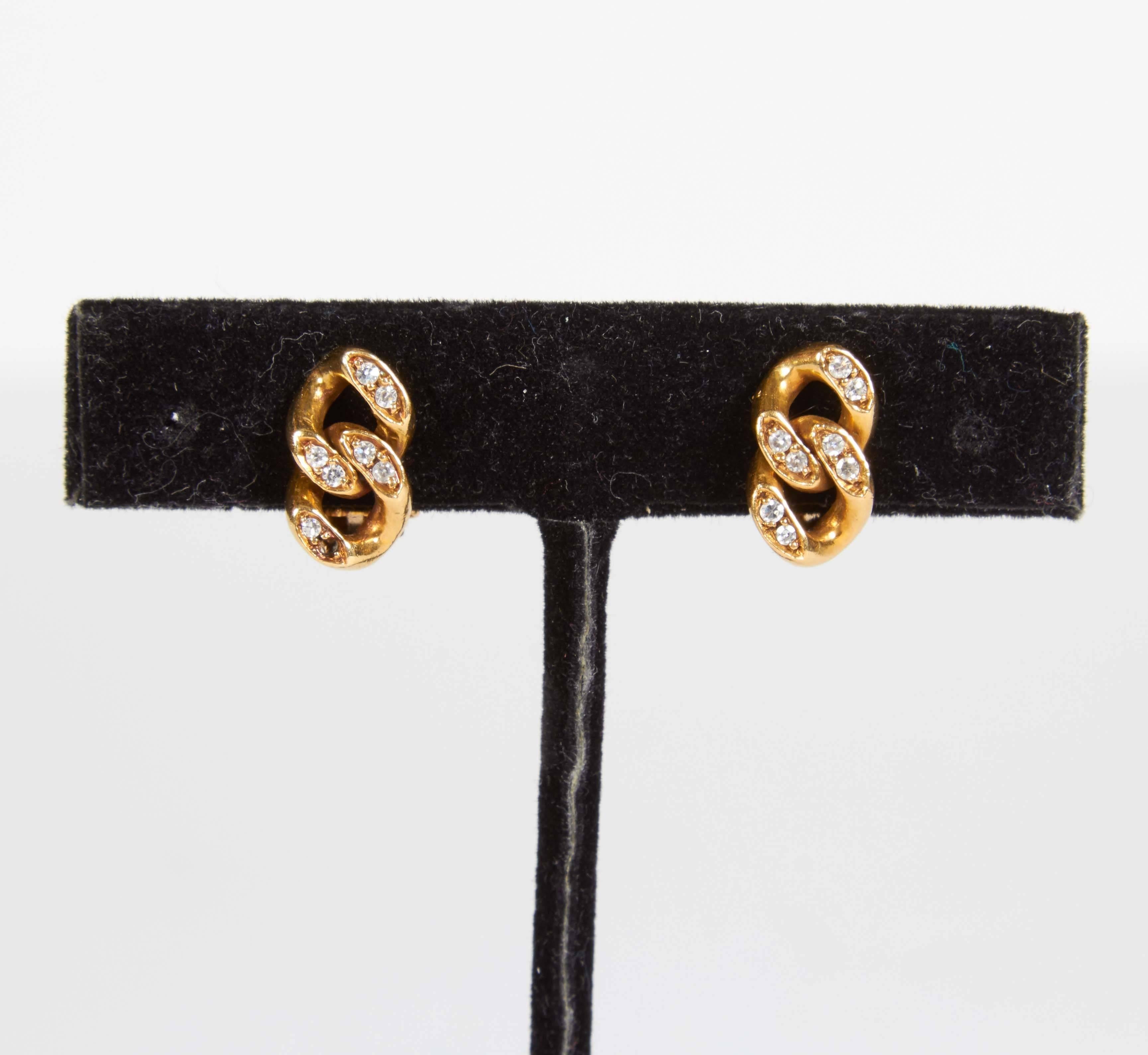 A lovely pair of Italian 18K gold with diamonds. Each earring has 8 diamonds and stamped 18K. A total of approximately 16 points in diamonds and combined weight of 7 grams for the pair. Clip back. Each earring measures 1/4 inch wide and a 1/2 inch