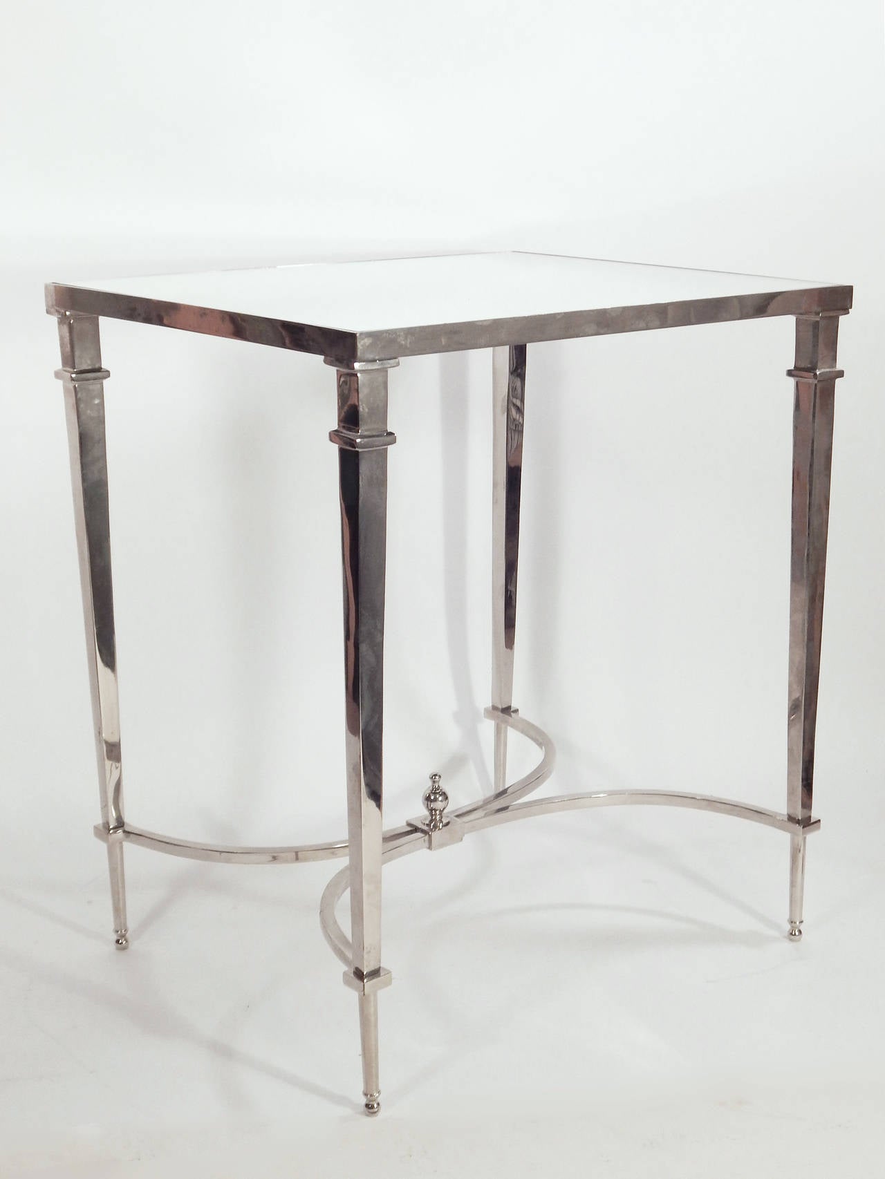 Pair of end tables in polished chrome with mirror tops.