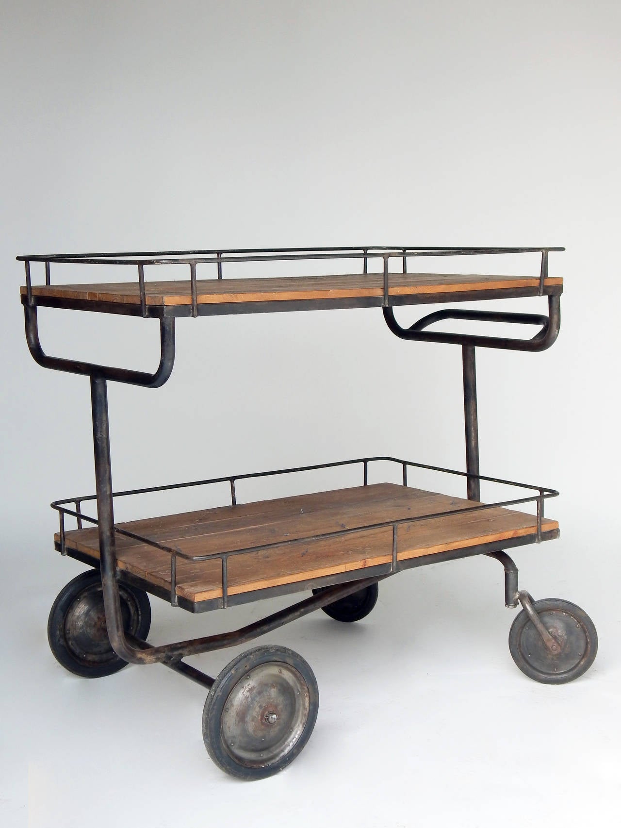 Industrial cart or trolley with antique wooden shelves.