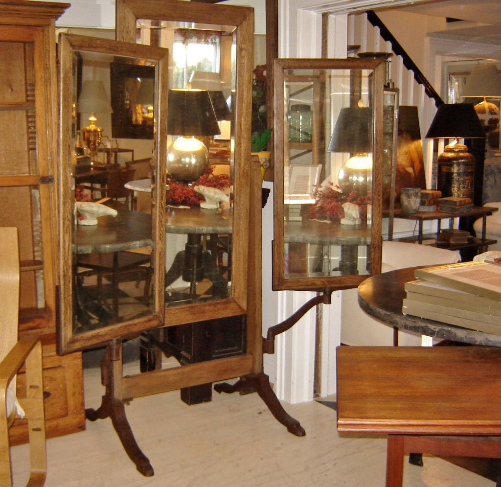 Handsome three panel oak  dressing mirror with iron hardware.In excellent condition. Slight age patina on mirrors adds to the look and doesn't really interfere with use. Side mirrors are 24