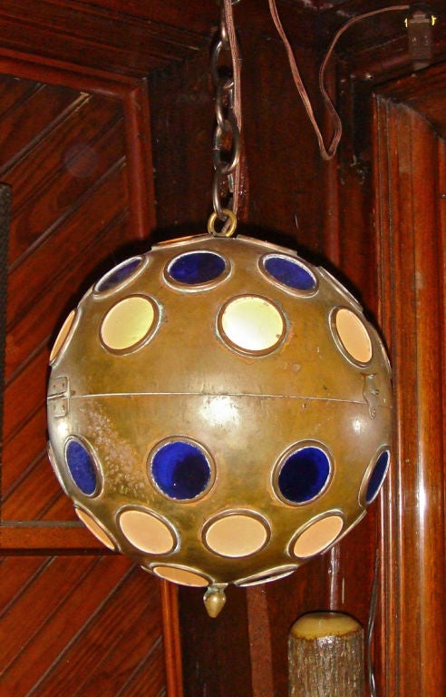 Wonderful brass ball fixture with blue and white glass inserts. This is the third one that I have had, all with different colored glass. Early disco lights?