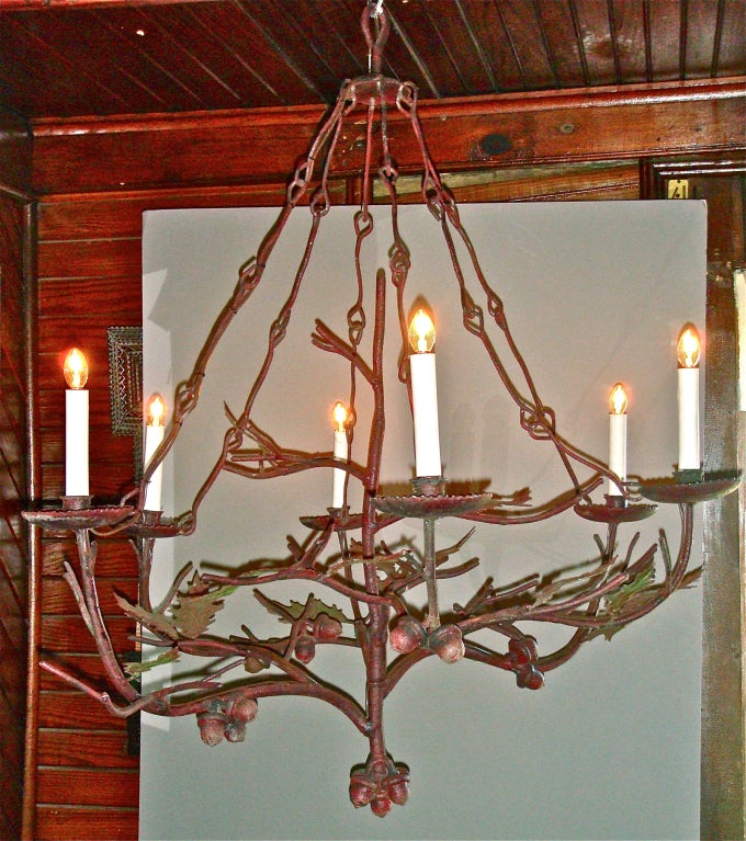 Oak leaf and acorn iron chandelier from the Adirondak Mountains. Original paint with great age patina. Was originally a candle chandelier but has been newly wired.