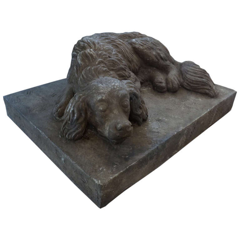 Charming cast cement sculpture of a sleeping spaniel. REDUCED FROM $1800.