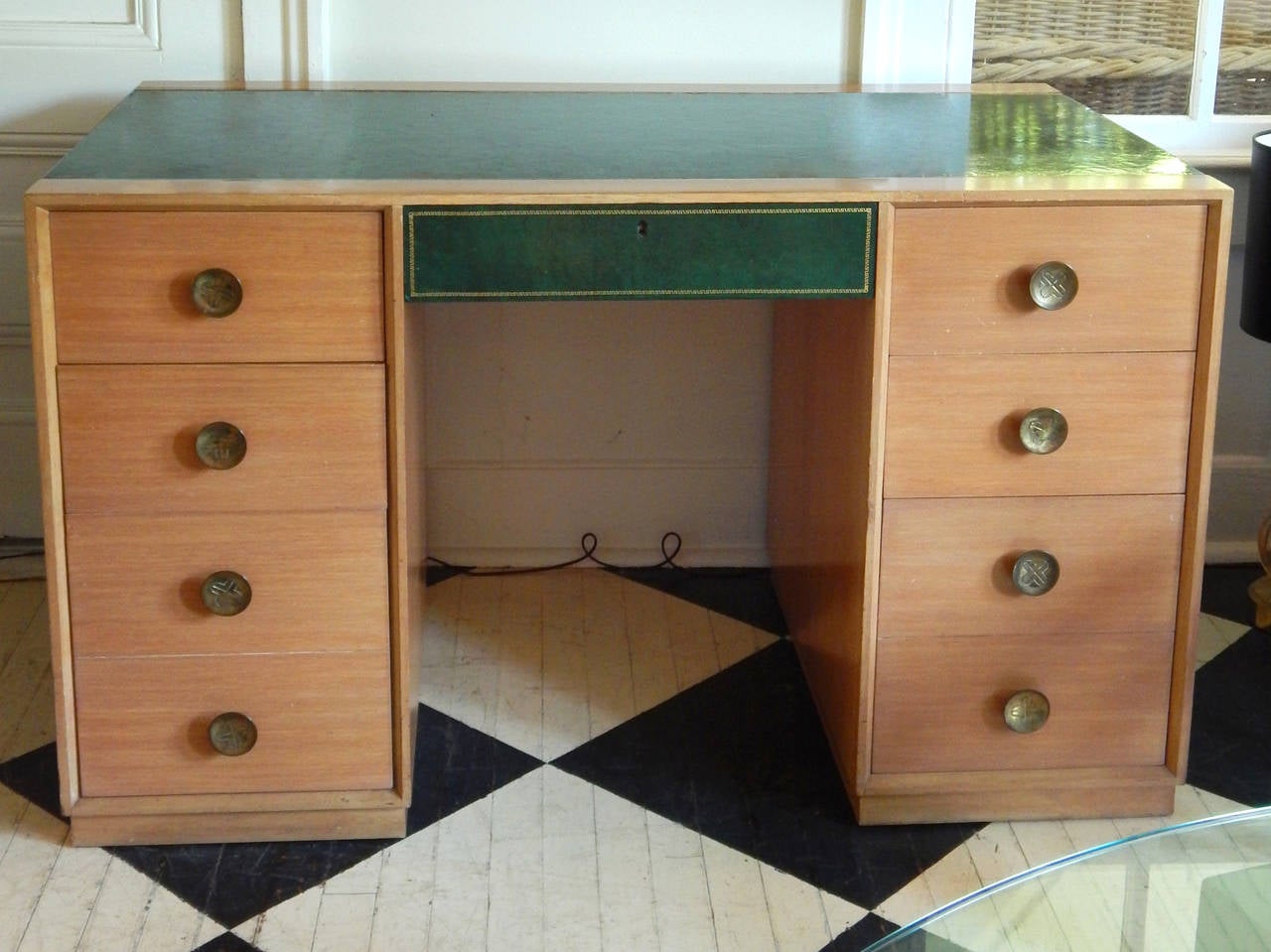 Tommi Parzinger blonde wood with green tooled leather desk. Fitted with drawers on one side and glass shelves on the other. The hardware is original and could be polished if desired.