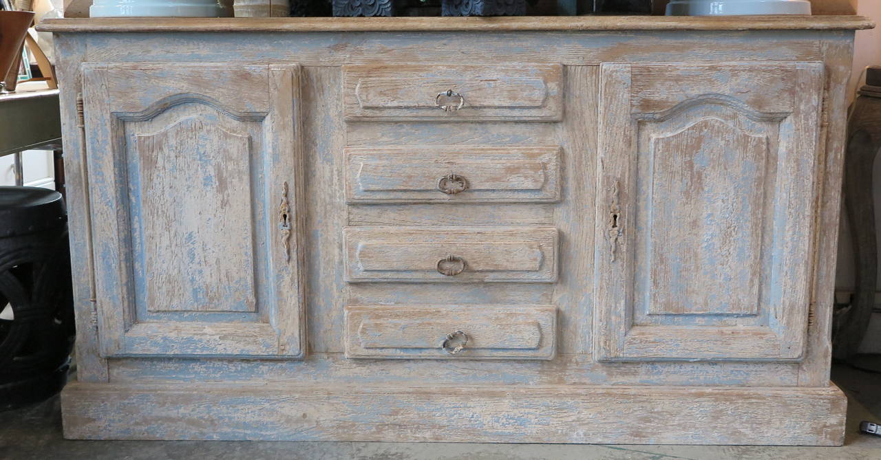 French sideboard in oak with rustic remains of old paint. Four drawers and two doors, offer great storage.