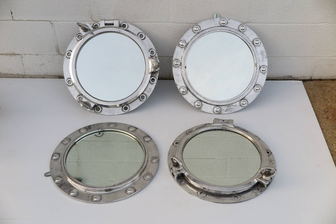 Mirrors made from the portholes from decommissioned ships. Sold separately, priced as follows: with latches $825, without latches $705. Please contact for current availability.