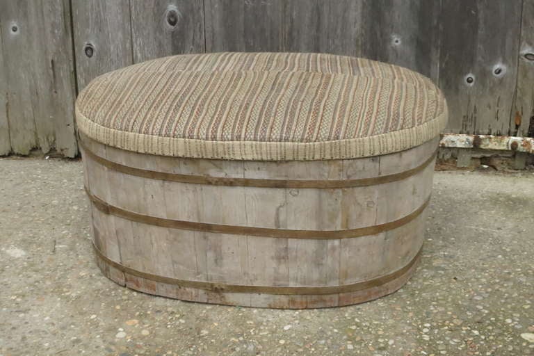 A 19th C Barrell with metal straps with later upholstered lid. The upholstered lid has been covered in vintage wool fabric. Perfect extra seating or ottoman
