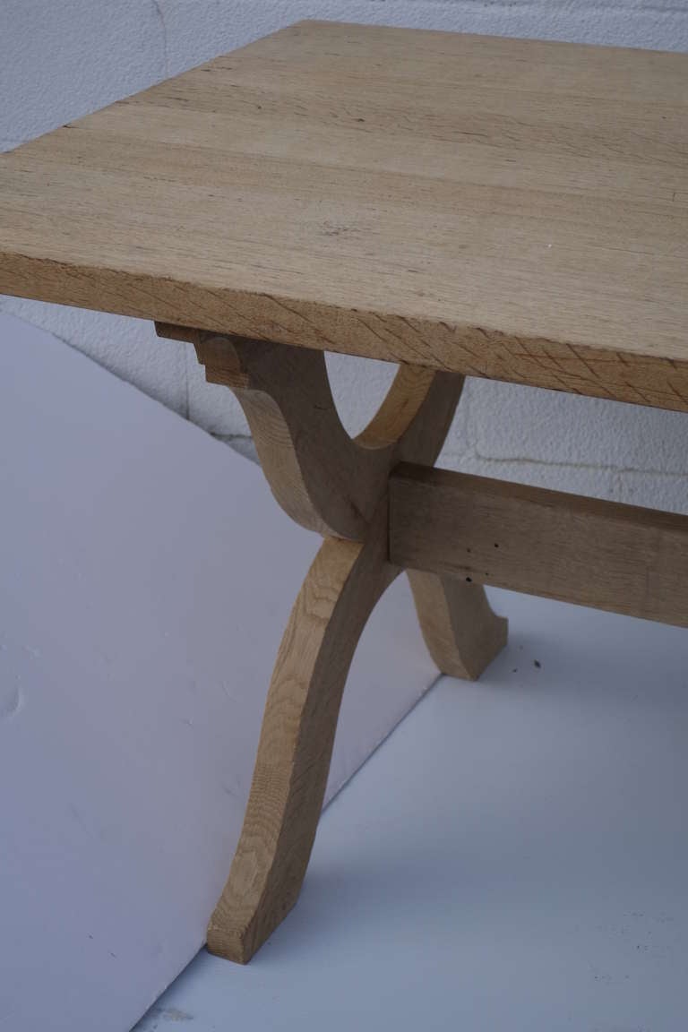 French dining table in a white washed finish, on inverted horseshoe ends. Please contact us for current availability.
