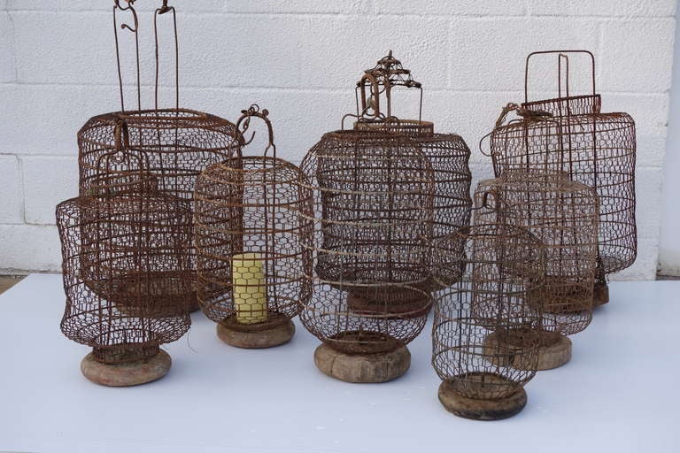 Charming antique hanging lanterns with wooden bases. Great for candles. Priced and sold separately, from $195 - $350.