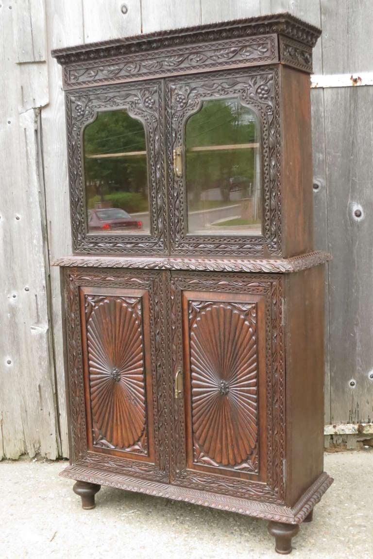 Indian decorative walnut cabinet. Intricately carved with a beautiful patina. Please contact us for current availability.