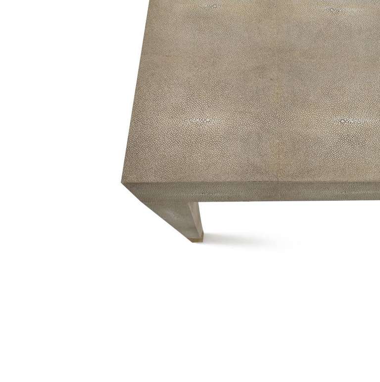 A stark statement in faux shagreen, this coffee table is a study on less is more. An elegant square top, gracefully tapered legs, and polished metal sabots make it a timeless classic. Please contact us for current availability.