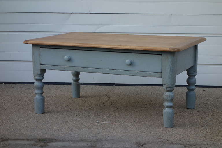 A low farmhouse style English Table with single drawer. Blue painted base, natural waxed top