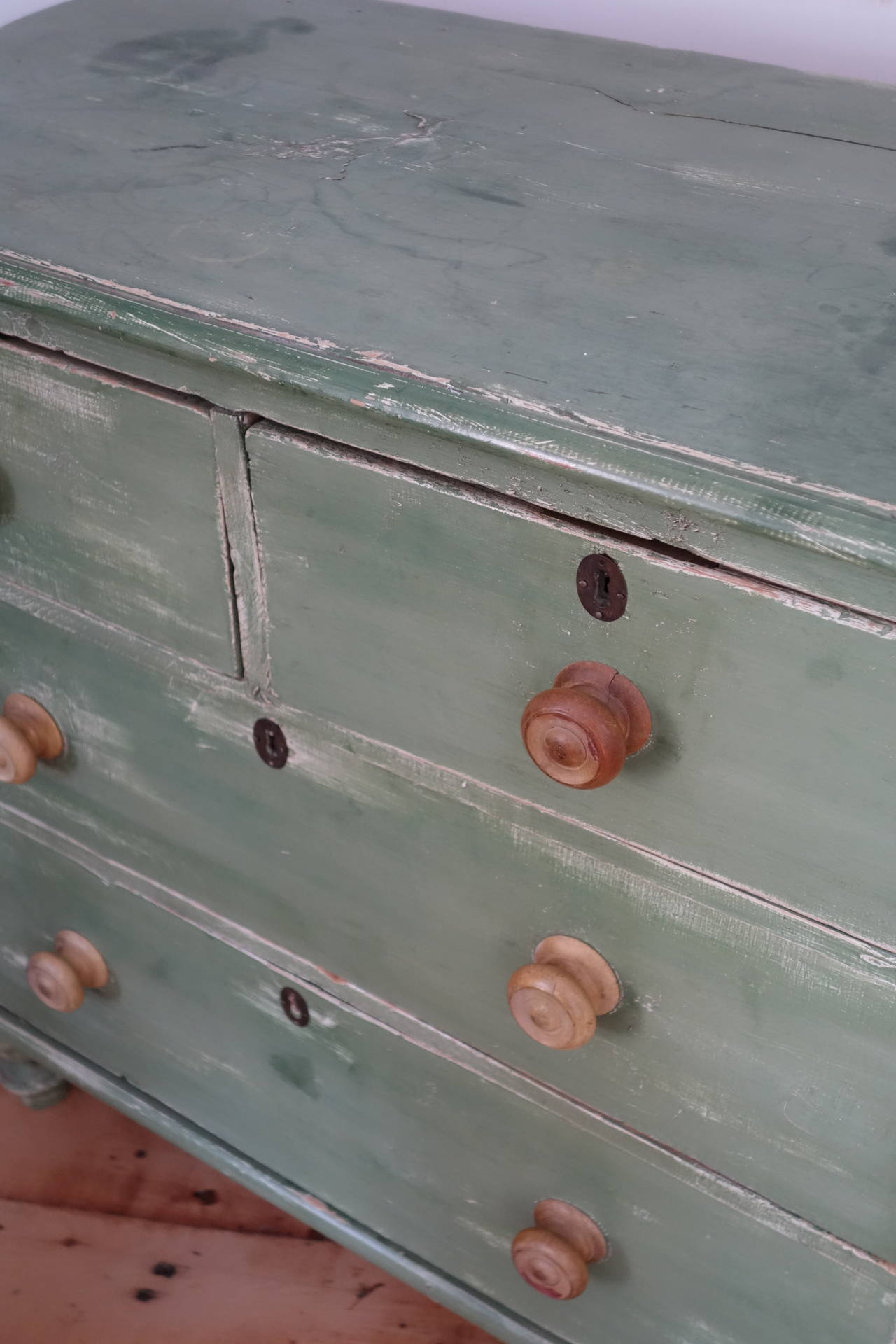 Charming English pine chest of drawers in old green paint, circa 1910.