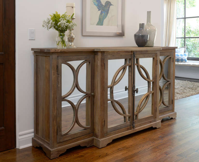 Sideboard with three cabinet spaces. Mirrored front adds a touch of elegance. Please contact for current availability.