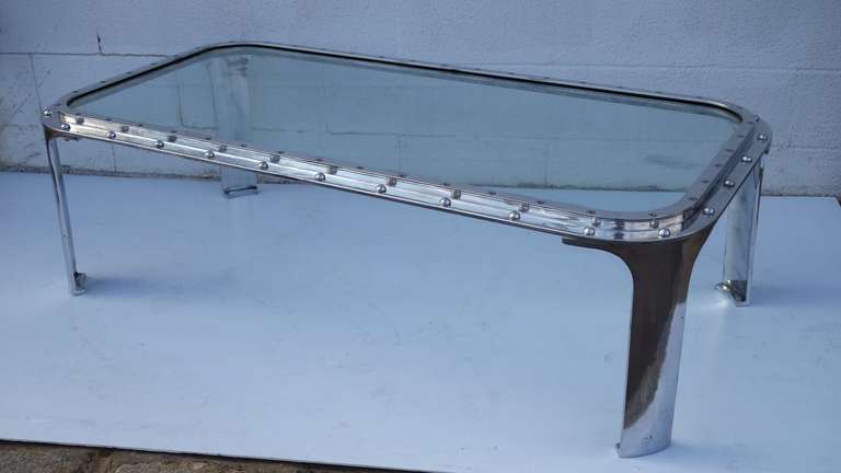 Porthole from decommissioned ship re-purposed as a stunning, simple coffee table with vintage flair.