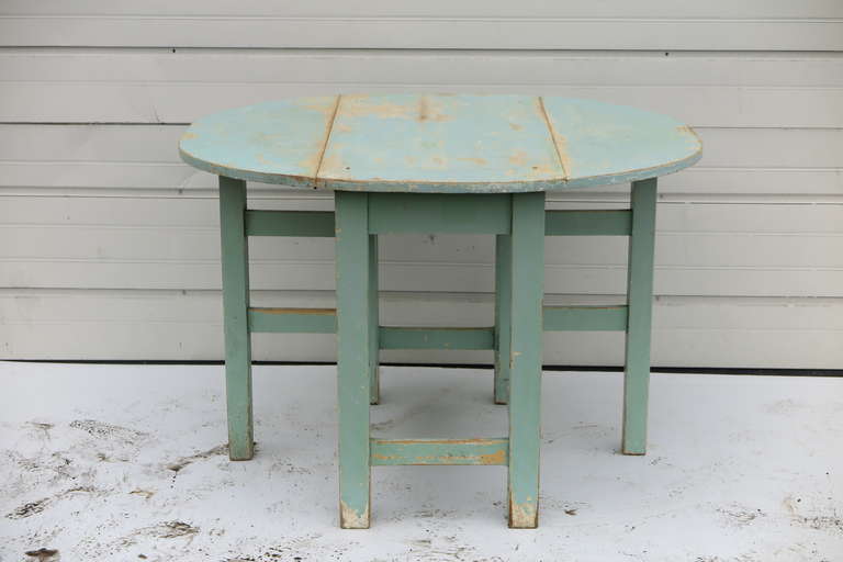 Old English pine gateleg table with original blue paint. width closed 20
