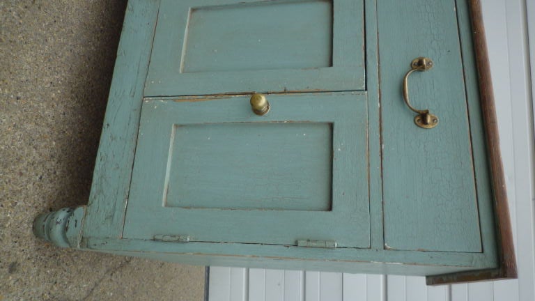 A large painted english sideboard with great storage. Original blue green paint and brass hardware. Waxed wood top.