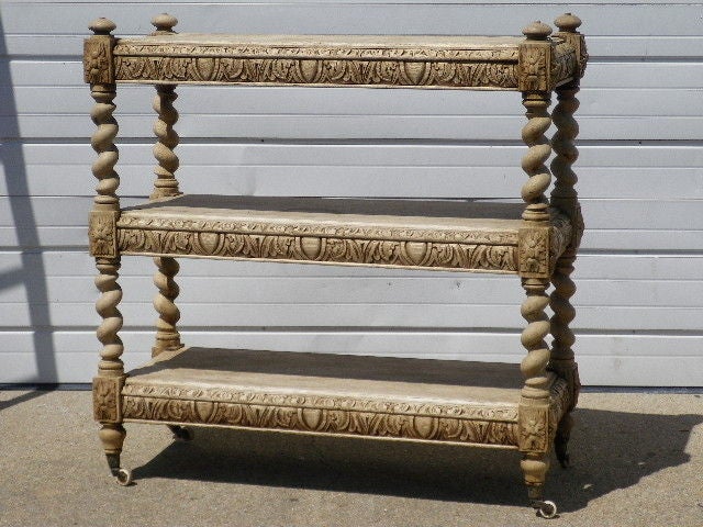 Intricately hand-carved bleached oak what-not on original casters.