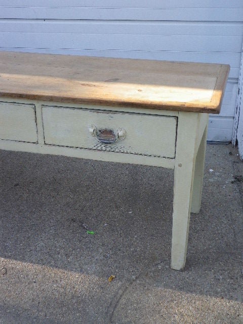 A useful, long narrow English pine sideboard or server with four large drawers fopr storage. Natural pine top with painted base.