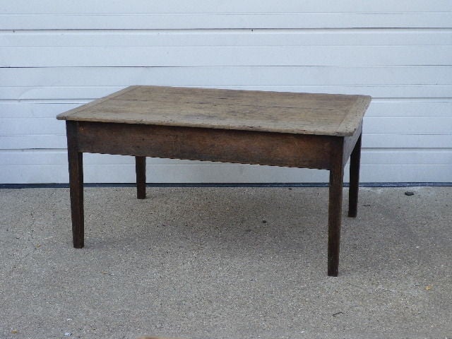 A low country table with tapered legs and bread board ends