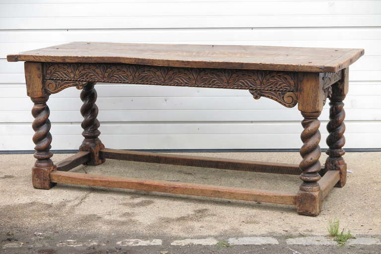 Welsh oak serving table features a decorative apron, thick handcarved legs and under all around stretcher. England c 1800. wonderful patina.