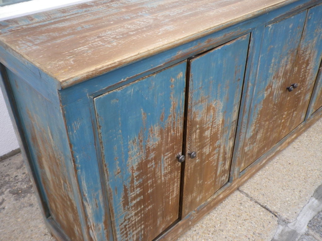 A very decorative long & narrow rustic style sideboard or server with 4 double doors. Great Storage