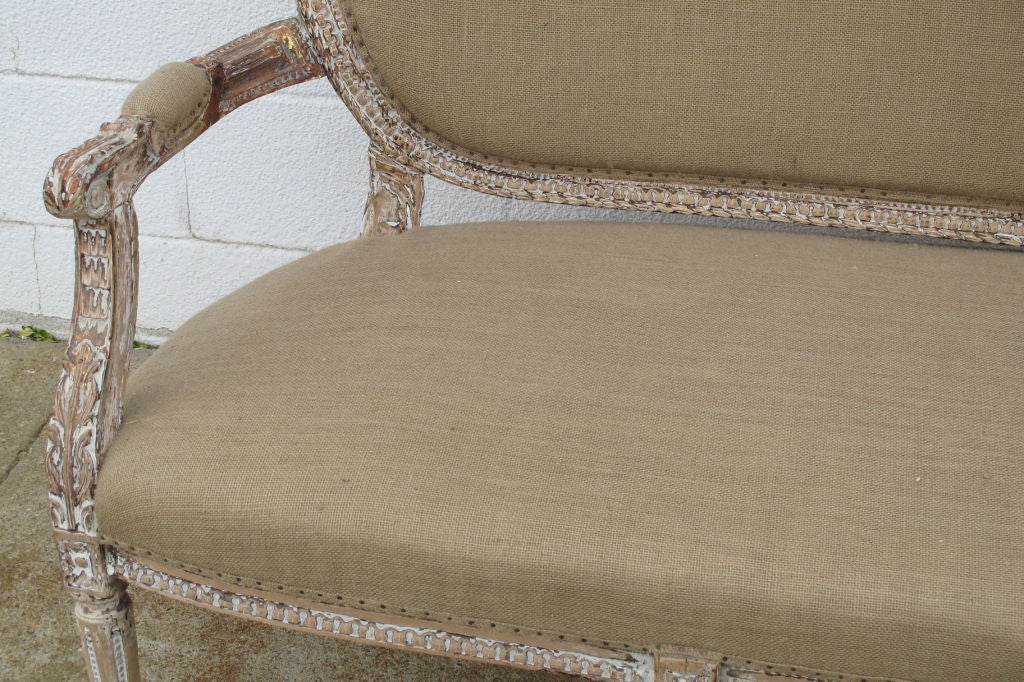 A mid 19th Century French Louis XV style Settee, recently upholstered in Burlap. All hand-carved frame, with the reamins of old gesso. This piece was probably painted or gilded originally.