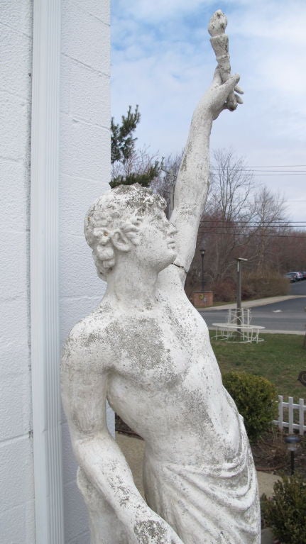A composition stone figure of young Prometheus holding a flaming torch. Remains of old white paint. His left arm is detachable as is the torch.
stands 6ft to head, 7ft10