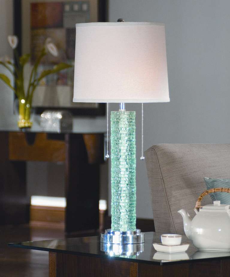 Aqua crystal chipped-edge table lamp on a silver base shimmers beautifully. Ivory paper shade.