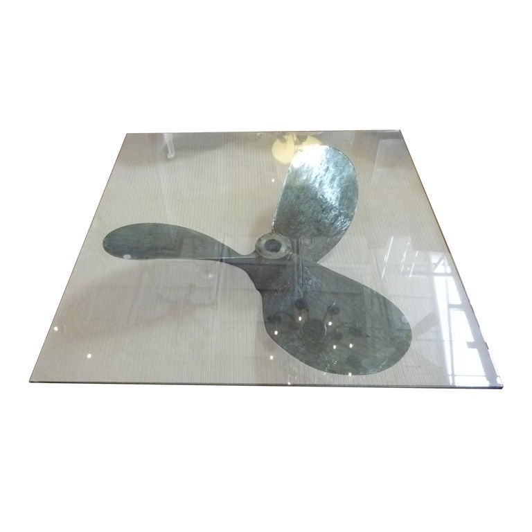 An old cast iron ship's propeller converted into a coffee table using a 3/4