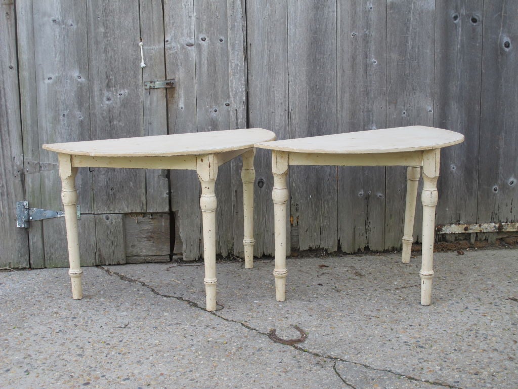 Pair of primitive painted demi lune tables in old ivory paint.
sold as a pair