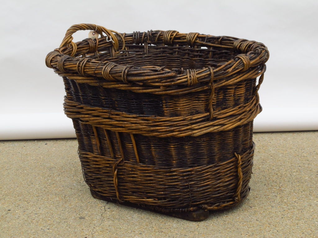 A 19th C French Grape Collecting basket from the Champagne region of France, great patina, lots of character, great for fire wood etc. Missing one handle.