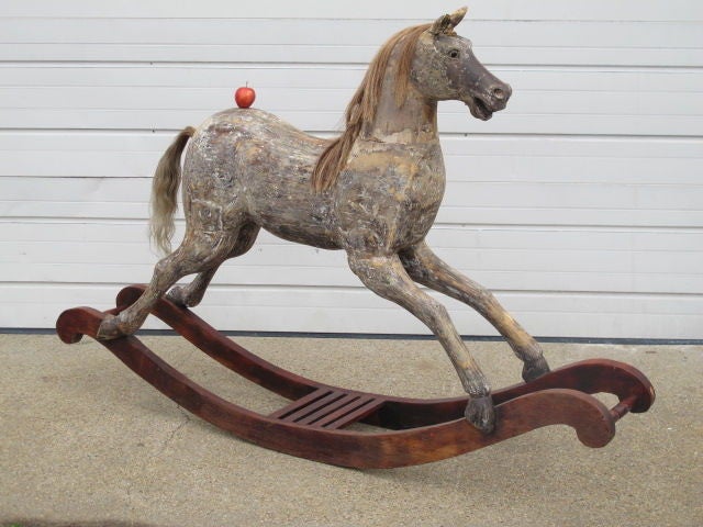 A Beautiful Lifesize Victorian rocking horse, with original mane and tail, and remains of old paint on polished wood stand. Wonderful patina and unusual full size.  

Dimensions: max height 55