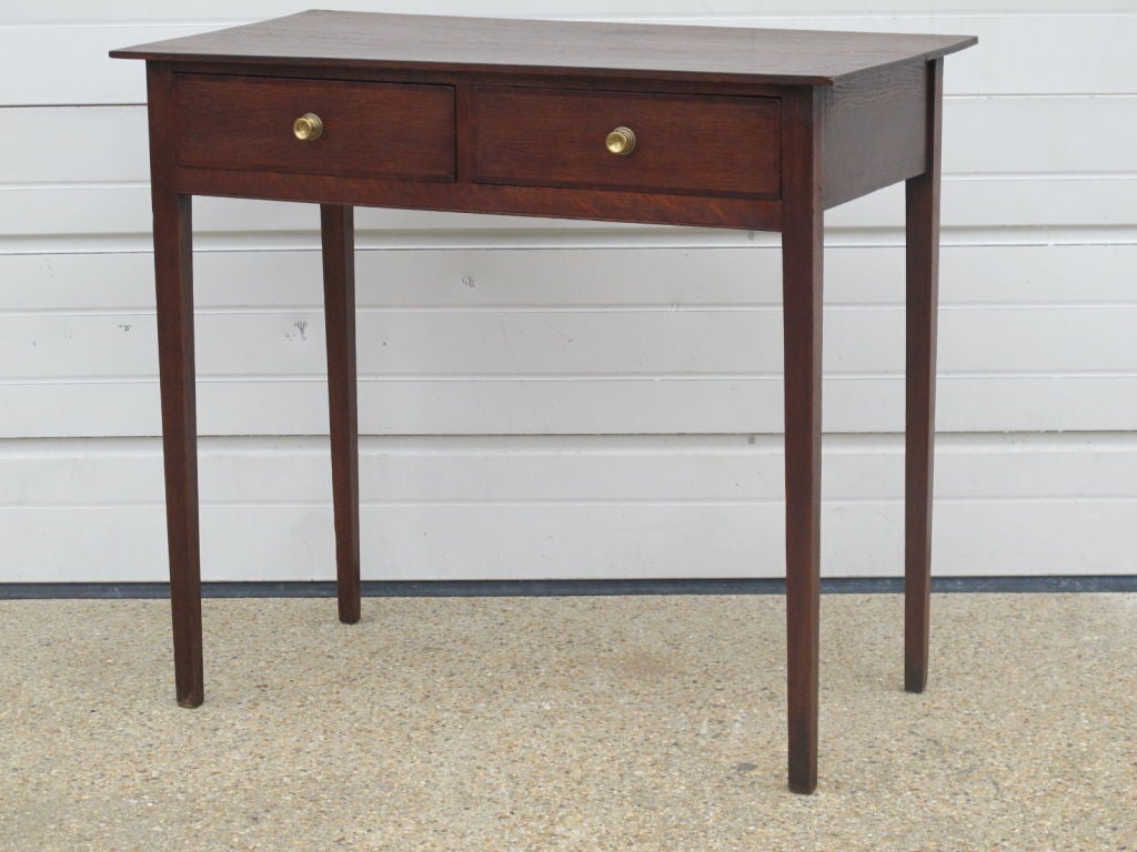Small English 19th C 2 drawer side table in Mahogany. Tapered Legs and Brass drawer pulls.