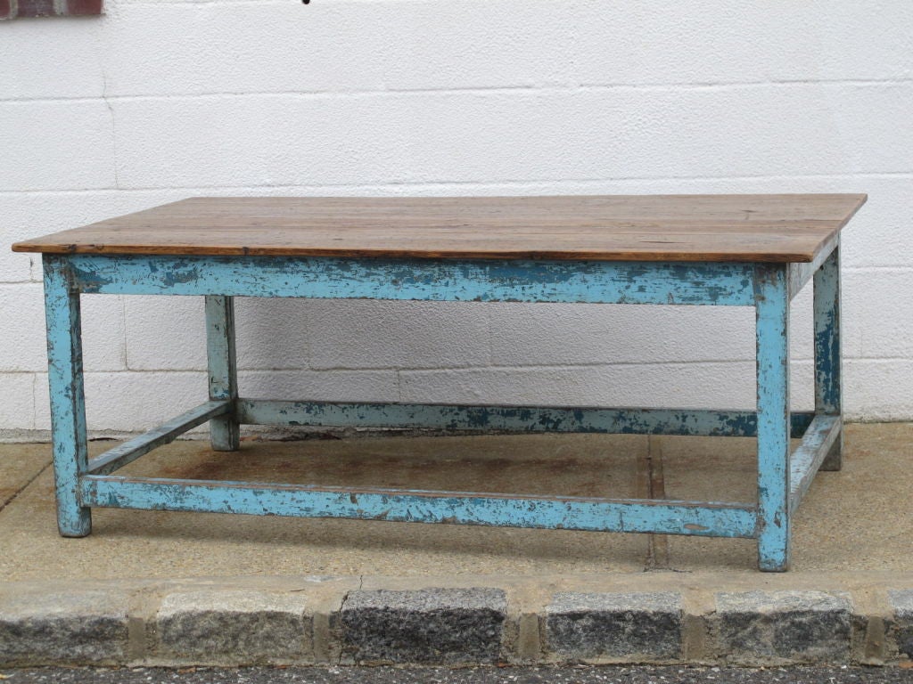 A English low painted table with remains of original blue paint on base and natural pine top with waxed finish