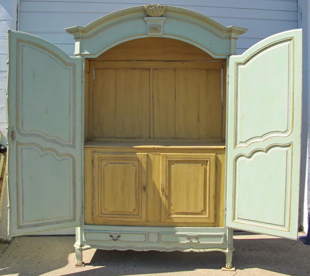 Magnificent French 19th Century painted Armoire with interior buffet.Unusual Louis XV style, hand carved details, stands on small cabriole legs. Exterior paint is pale turquoise, interior, mustard yellow. Original hardware. Exceptional piece.