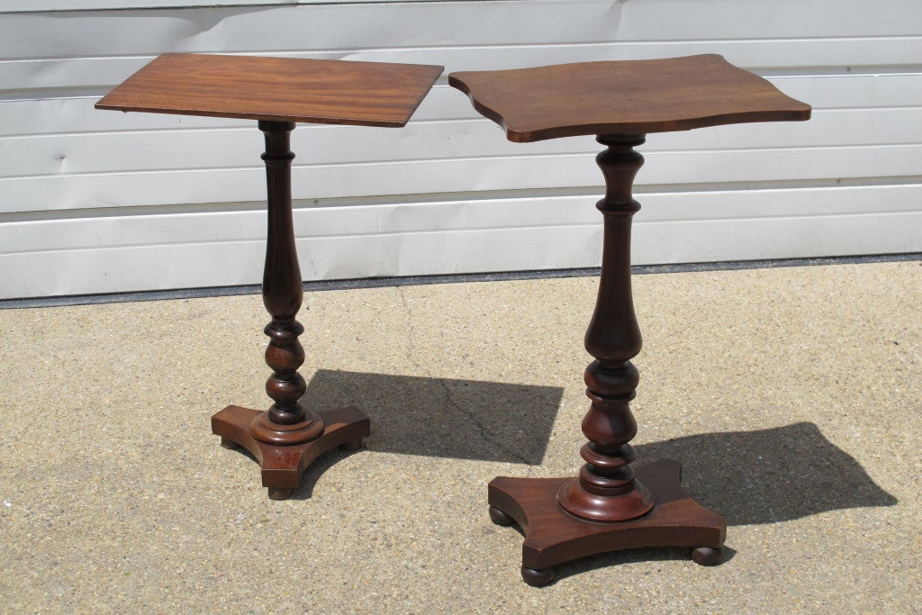 English mahogany pedestal tables with turned stands and shaped bases on bun feet. 
Sold separately, from $1440 each.  

Left table measures 19" x 13" x 26.25"H. 
Right table measures 17.25" x 13.25" x 29"H.