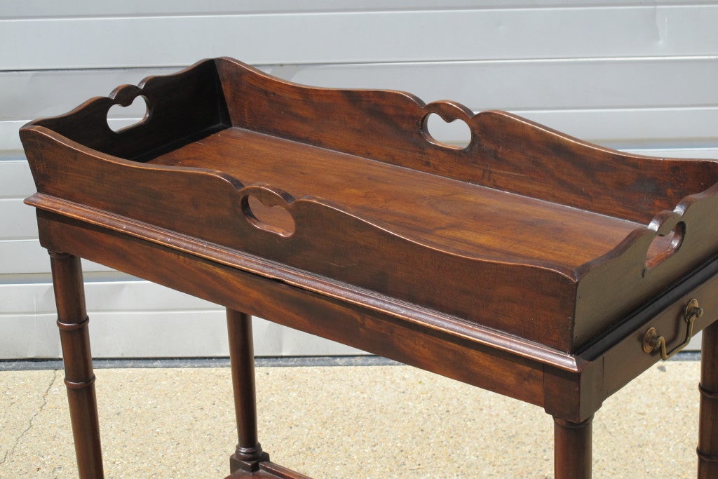 An English 19th C Butlers Table with removeable tray and side storage drawer. Original Brass casters