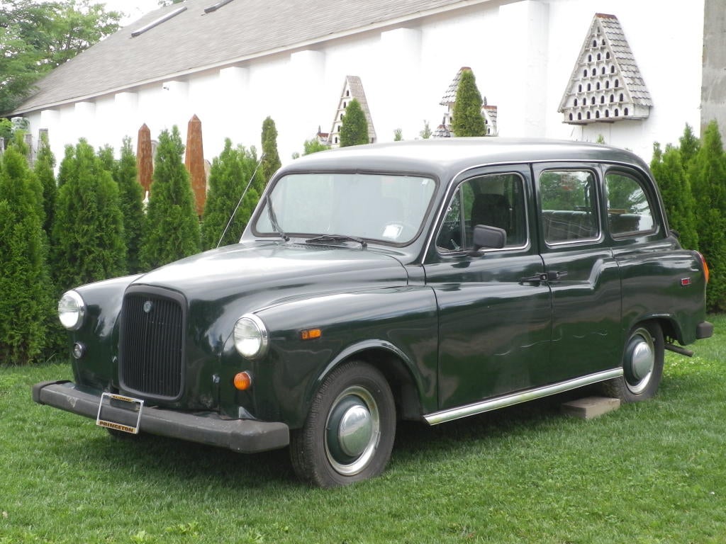 left hand drive British Taxi Cab. c 1968. dark green exterior.