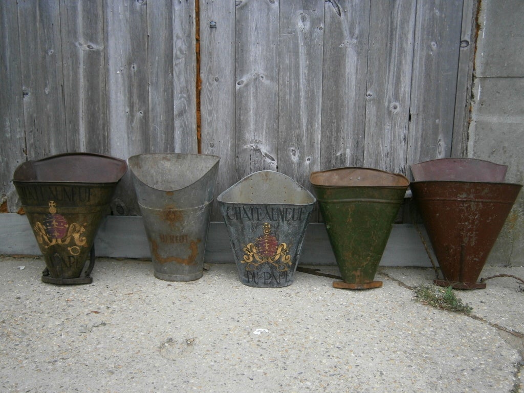 We have a collection of old French grape collecting buckets, some with vineyard names & coat of arms decoration. ( recent addition). sold separately from $ 850 - $ 1150 each