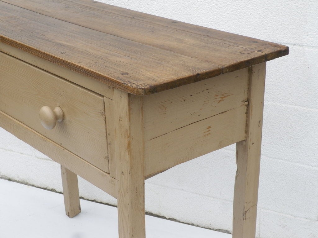 A rustic style English side table with large single drawer, painted pine base, stained waxed top