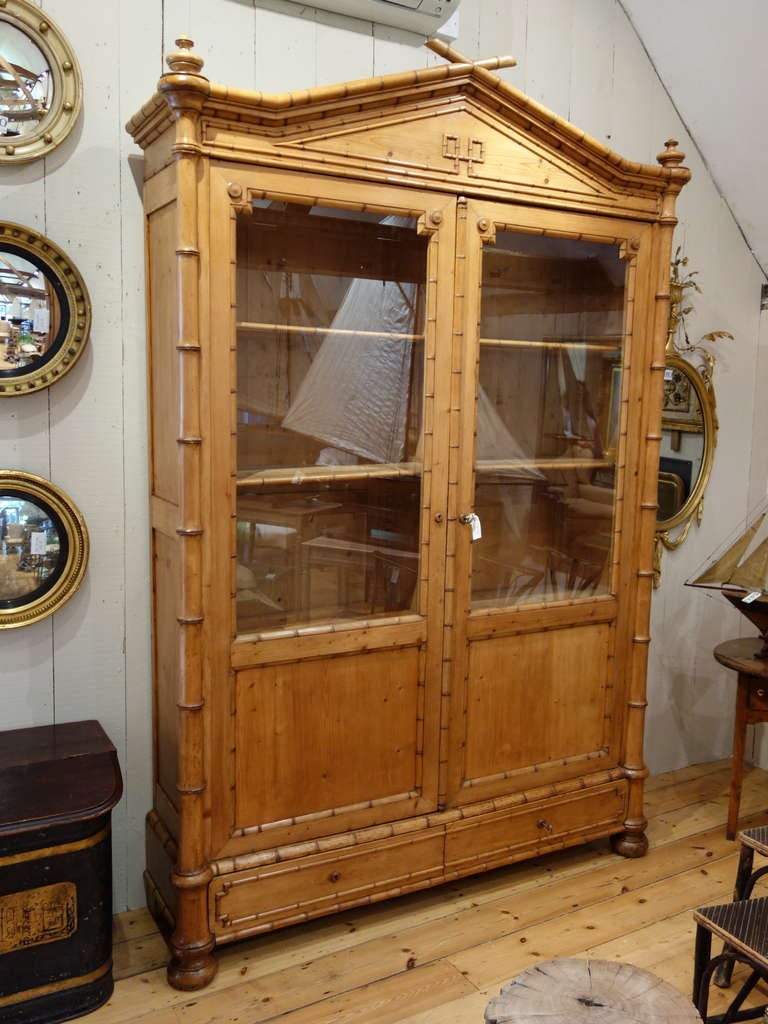 Large 2 door French 19th Century Faux bamboo cabinet with glass doors. Circa 1880
2 drawers at base. lovely color and condition.