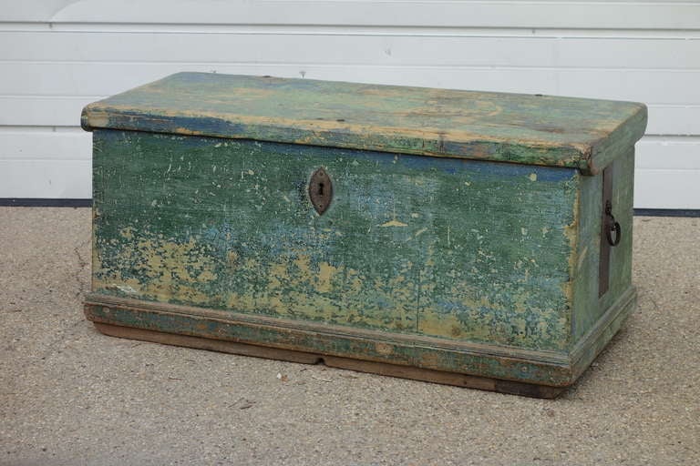 A 19th C pine Trunk with remains of original paints, and unusual decoration to the underside of the lid. Original handles, lock and hinges. Lovely color