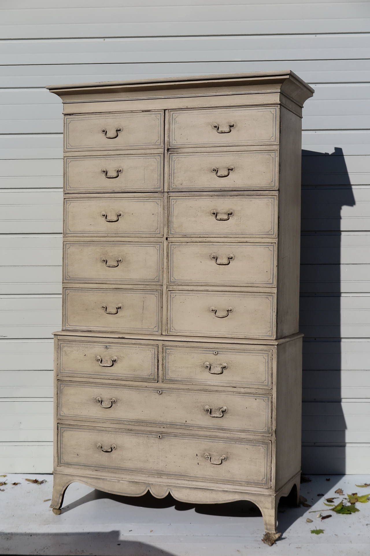 Highboy or chest on chest with faux front cabinet doors revealing three shelves in upper portion of chest. Lower chest consists of two short drawers over two long. Painted finish done at a later date. Please contact for current availability.