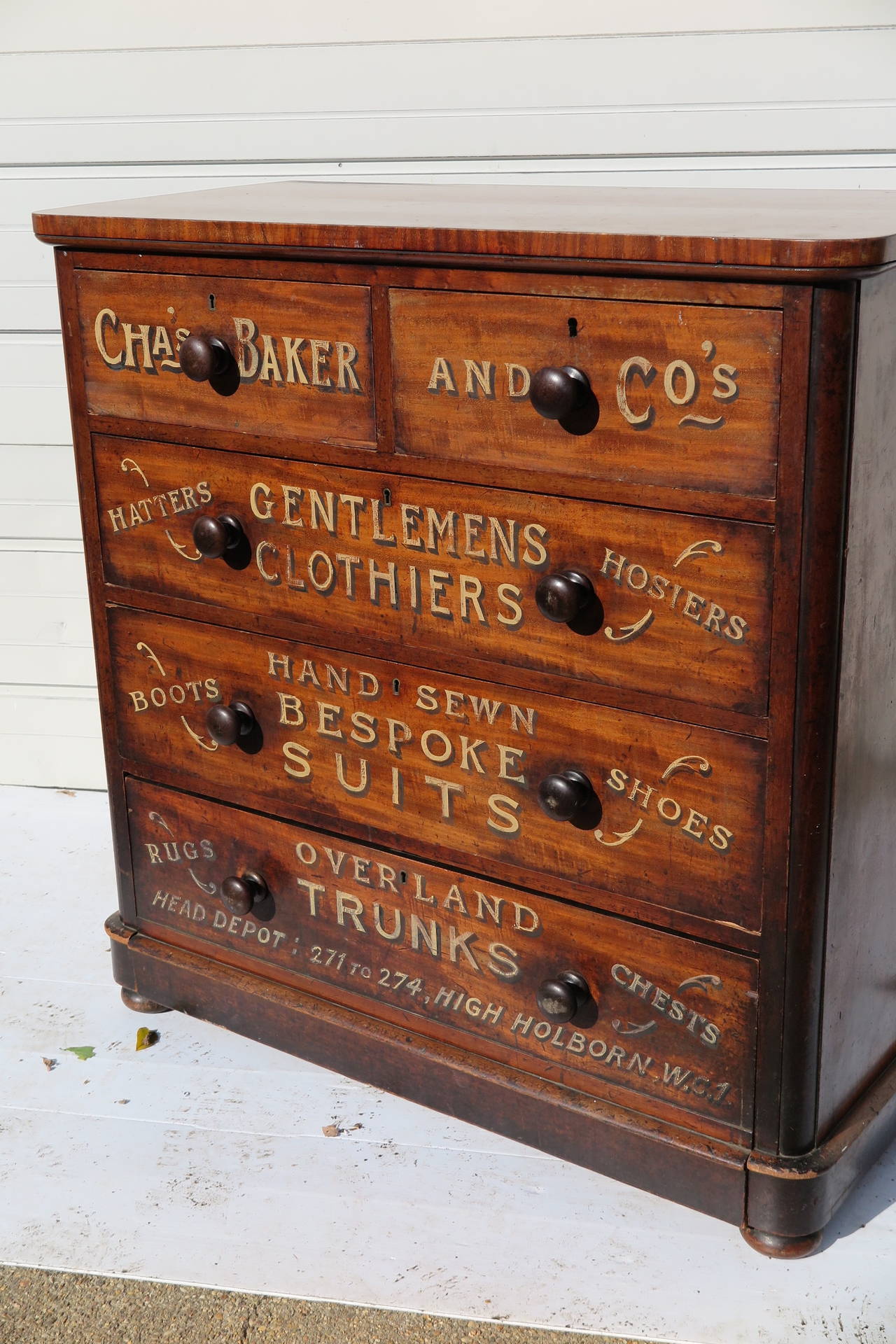 Large English dresser, circa 1900, with later painted advertising for Chas. Baker & Co. Gentlemen Clothiers of London. Five drawers, bun feet, original wooden handles. Others available.