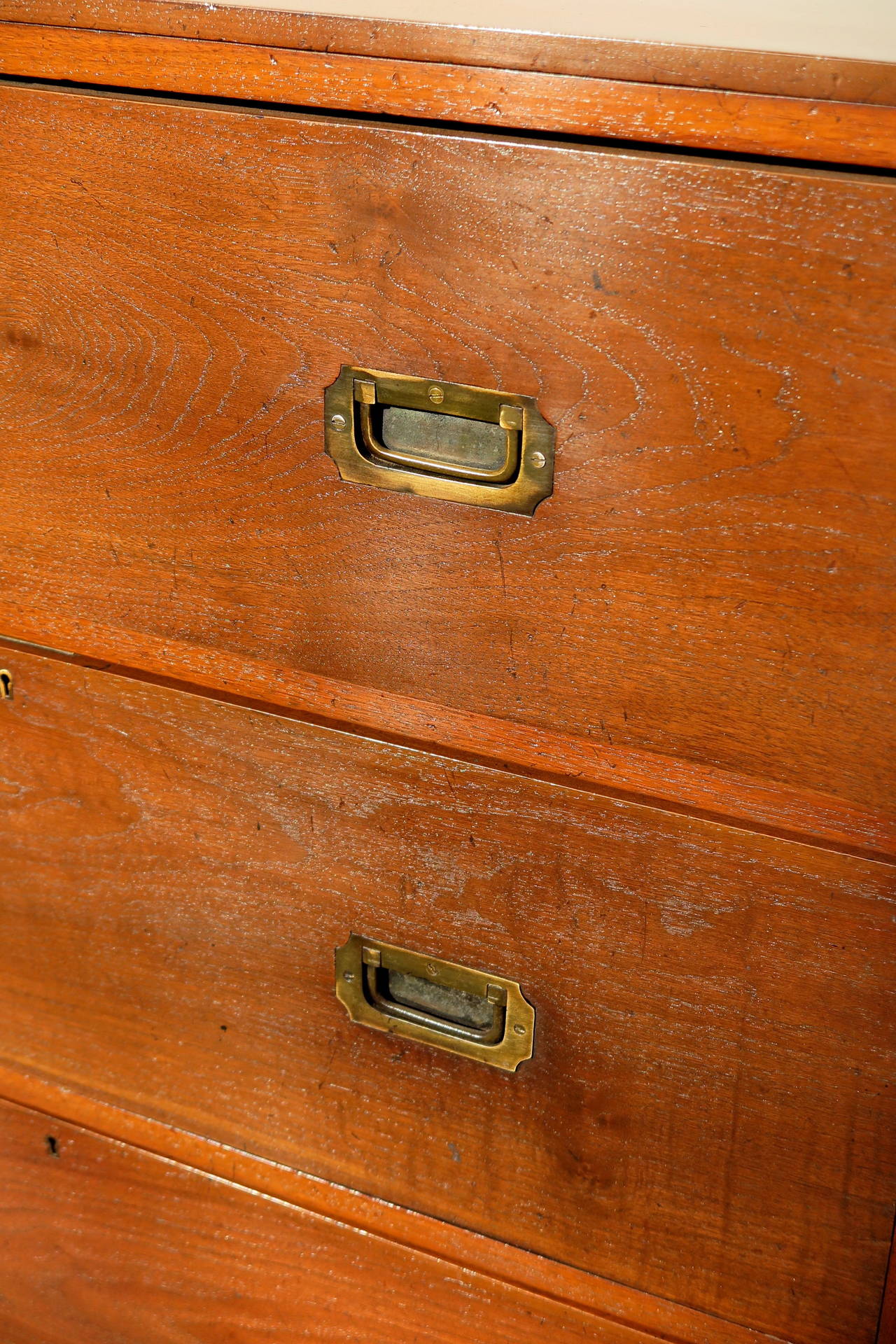 English Campaign Dresser or chest of drawers, with original brass hardware, bun feet.
