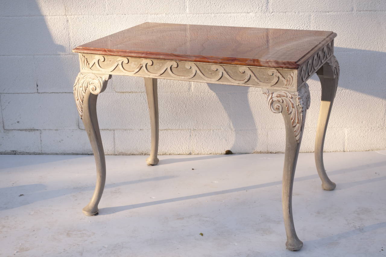 Beautiful original marble top over carved wave motif frieze on cabriole legs with later painted finish. Please contact for current availability.