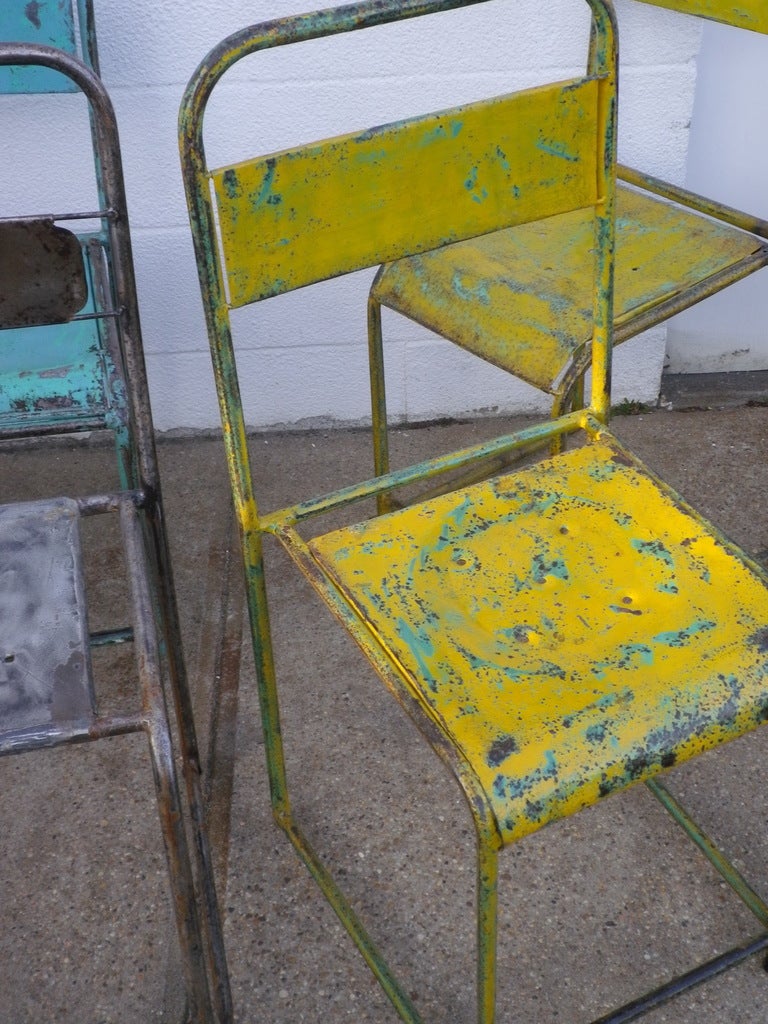 Asian metal cafe chairs with remains of old blue and yellow paint. stackable. sold by the set of 6. $ 950 a set. any combination of colors.