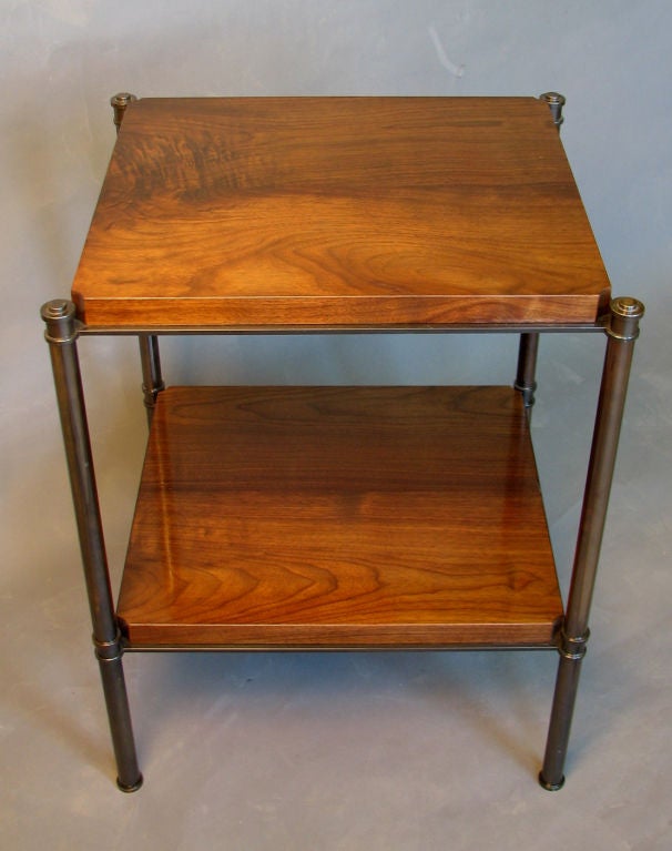 A side table designed by F.P. Victoria & Son shown with thick plank-style American walnut shelves bordered by a projecting metal lip and supported by a custom black nickel-plated brass frame.